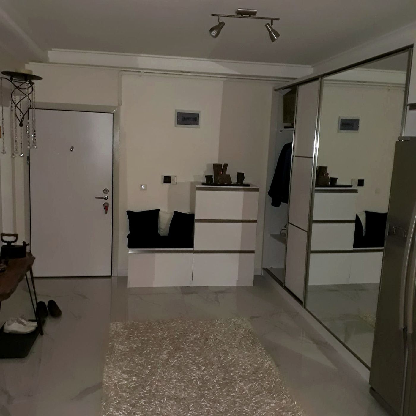 Antrede beyaz vestiyer dolapları ve giriş kapısı